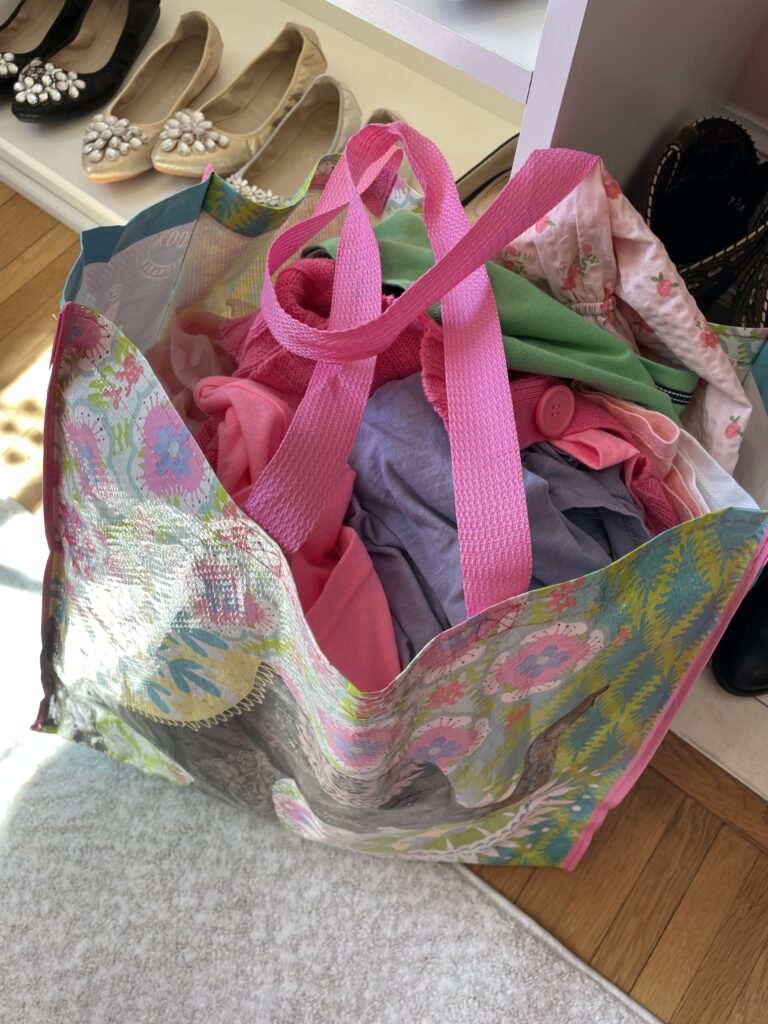 Colorful bag full of clothes to be donated to Goodwill