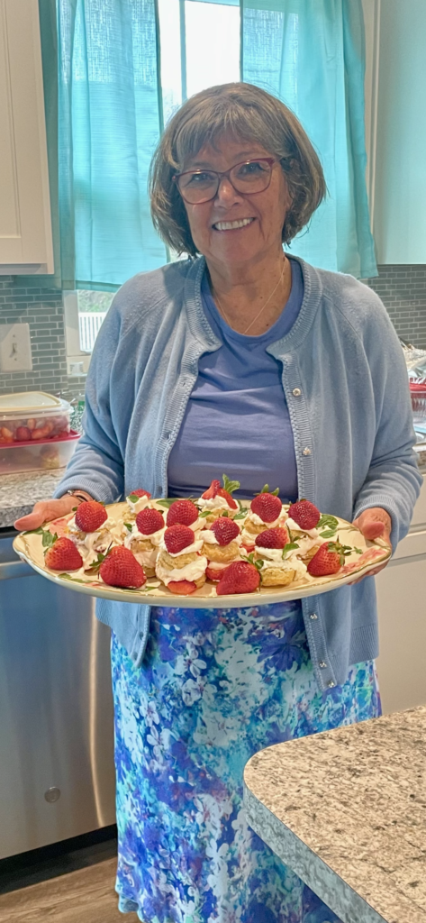 I am holding a platter of strawberry shortcakes