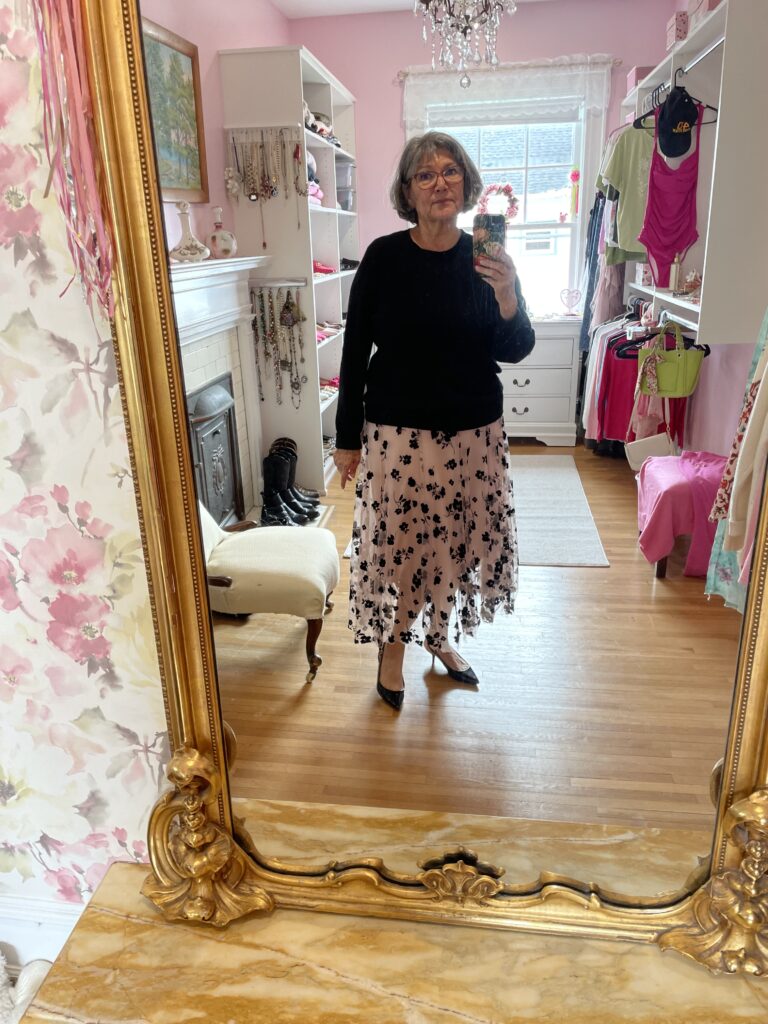 # 16 Black and pink floral skirt, black cashmere sweater