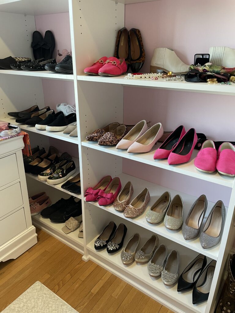 Rows of shoes, pink, black and with sparkles