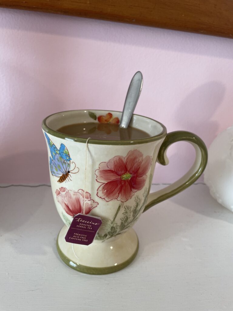 "Milky Tea" Teccino Vanilla Nut tea with a spoon of honey and a splash of soy milk in a floral mug